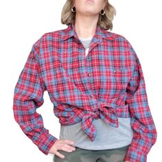 This vintage shirt is a must-have for any casual and androgynous outfit. The red and blue plaid pattern perfectly complements the 90s decade style, while the cotton blend material ensures comfort. This original piece features a button-up design with roll tab sleeves and a chest size of 22 inches, making it a great fit for women's size L/XL. Whether you're going for a laid-back, everyday look or dressing up for a retro-themed event, this shirt is a versatile addition to your wardrobe. Its shoulde Retro Plaid Flannel Top, Androgynous Outfits, Blue Plaid Pattern, Flat Chest, Vintage Shirt, Chest Size, Blue Plaid, Button Up Shirt, Plaid Pattern