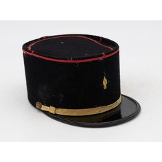 A rare French Military Academy Officer's hat or cap from the 1970s. These special and unique hats are part of the uniform of students studying to become officers in the French Military. This cap features a black leather brim on black felt with a red braid around the top, a gold band across the brim with gold studs, and a gold emblem on the front. 6.25"w x 10"d x 4.25"h. Wear consistent with age and use. Black Military Brimmed Hat, Black Brimmed Military Hat, Black Hat With Short Brim For Ceremonial Use, Black Ceremonial Hat With Short Brim, Black Short Brim Hat For Ceremonial Use, Black Short Brim Hat For Ceremonial Occasion, Black Short Brim Ceremonial Hat, Black Brimmed Hat For Ceremonial Occasions, Vintage Black Ceremonial Hat