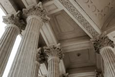 an old photo of some pillars in a building