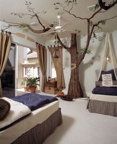 a bedroom decorated with trees and hammocks hanging from the ceiling