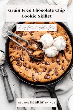 a chocolate chip cookie in a skillet with ice cream on top and the words, grain free chocolate chip cookie skillet