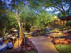 an outdoor dining area is lit up at night