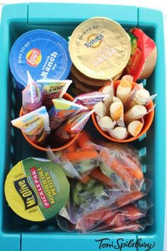 a blue plastic container filled with food and condiments