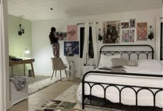 a woman is painting the walls in her bedroom