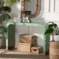 a green console table with baskets under it and a mirror on the wall behind it