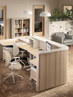 an office with two desks, chairs and a book shelf in the middle of the room