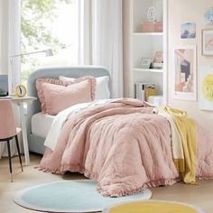 a bed room with a neatly made bed and pink comforter