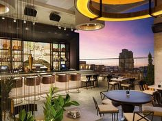 a restaurant with tables and chairs overlooking the city