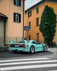 a blue sports car is parked on the street