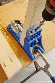 a drill is being used to make a piece of wood