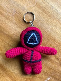 a crocheted keychain shaped like an astronaut