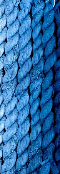 several skeins of yarn are stacked on top of each other in shades of blue