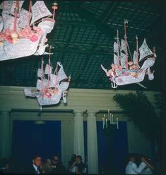 two paper boats are hanging from the ceiling