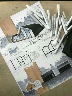 architectural drawings and pencils laid out on a table