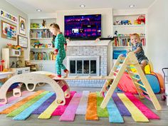 two children playing in a play room with colorful rugs