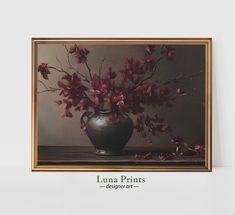 a painting of red flowers in a black vase on a white table with the words luna prints below it