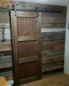 a room with wooden walls and doors made out of pallet boards, wood flooring