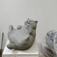 a white cat statue sitting on top of a table