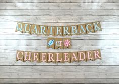 the banner is hanging on the wall next to another sign that says, quarterback or cheerleader