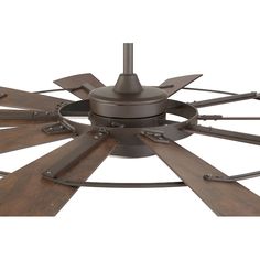 a ceiling fan with four wooden blades and metal accents on it's face, viewed from the bottom