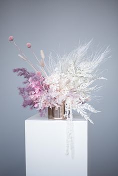 a vase filled with flowers on top of a white table