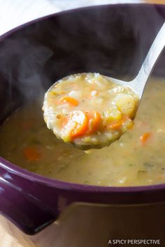 a spoon full of soup is being held up