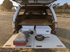 the back end of a white van with tools in it's cargo compartment and an open hatchback door