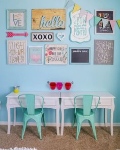 a bedroom with blue walls and pictures on the wall above two desks in front of a bed