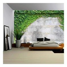 the bedroom is decorated in white and has green ivy growing on the wall behind it