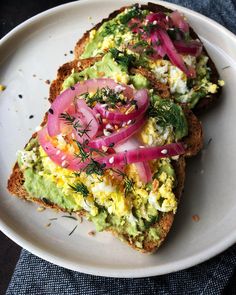 two slices of toast with vegetables on them