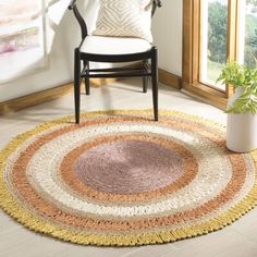 a chair sitting in front of a window next to a rug