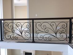 a balcony railing with wrought iron work on it's balconies in a home