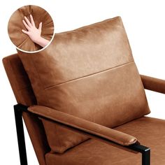 a brown chair with a hand resting on the armrest and an extended arm rest