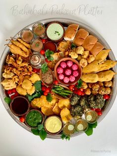 a platter filled with different types of food and condiments on top of each other