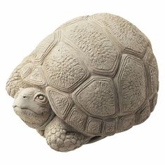 a turtle statue sitting on top of a white surface