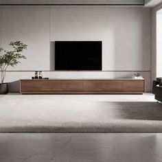 an empty living room with a large television on the wall