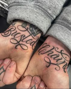 two people holding hands with tattoos on their arms and the words love are written in cursive font