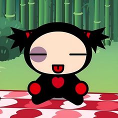 a cartoon character sitting on top of a red and white checkered tablecloth with bamboo trees in the background