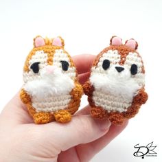 two tiny crocheted animals sitting on top of each other in someone's hand