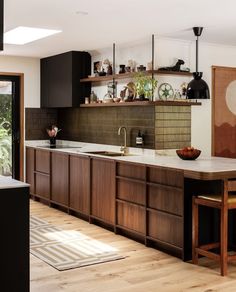 an open kitchen with wooden cabinets and counter tops, along with a dining room table