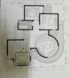 a drawing of a living room and dining area in a house with blueprints on the floor