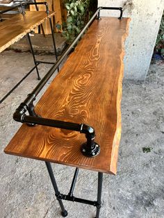 a wooden table sitting on top of metal legs