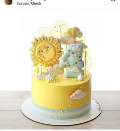 a yellow and blue birthday cake with the number four on it's bottom tier