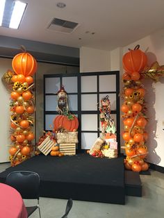 an arrangement of pumpkins and other decorations on a stage