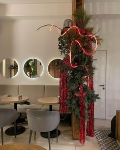 a room with chairs, tables and lights on the wall above them is decorated with red fringes