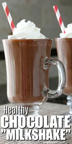 two glasses filled with chocolate milkshake and whipped cream