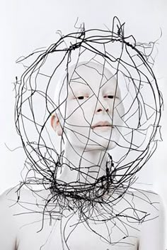 a woman with her face covered in wire