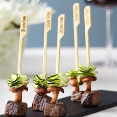 four forks sticking out of some food on top of a table