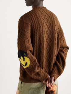 Careful production methods are at the heart of KAPITAL's design philosophy. This sweater is cable-knitted from wool yarns specially selected for their soft handle. The elbows are intarsia-woven with the label's smiley logo. Smiley Logo, Latest Sweater, Sweater For Men, Knitwear Men, Brown Sweater, Wool Blend Sweater, Rhubarb, Mr Porter, Black Wool