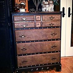 a brown dresser with lots of drawers and knobs